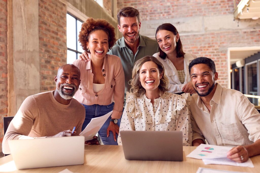 Diverse team of professionals collaborating in a modern workplace, representing employee engagement and talent retention