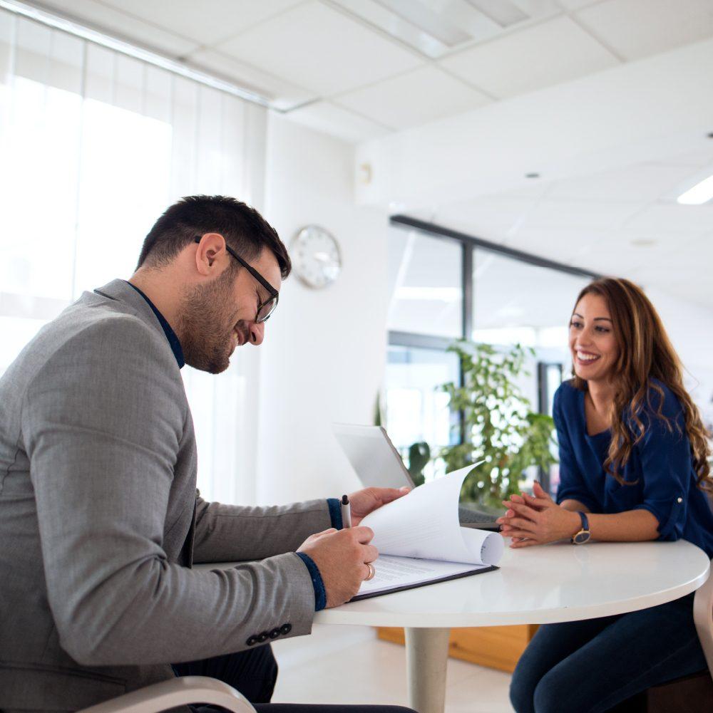 Recruiter reviewing a candidate’s documents during a temporary staffing interview